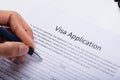 Person Filling Visa Application Form