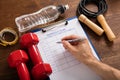 Person Filling Workout Plan Form With Workout Equipments Royalty Free Stock Photo