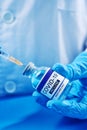 Person fills a syringe with a mock covid-19 vaccine