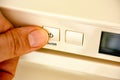 Person finger pressing an on off button Royalty Free Stock Photo