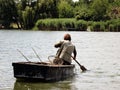 Person Fishing in the River from a boat