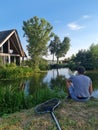 A person fishing in a rural area in the Netherlands.