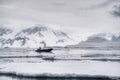 A person floating on motorboat through the floe