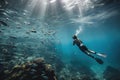 person, floating among schools of fish in scuba diving and snorkeling