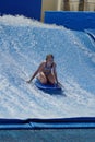 Person on a `flowrider` surf simulator