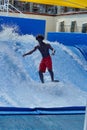 Person on a `flowrider` surf simulator