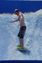 Person on a `flowrider` surf simulator