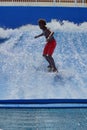 Person on a `flowrider` surf simulator