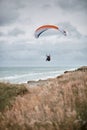 A person flying a kite in a large body of water