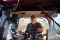 Person focused on controls inside tractor while working outdoors Royalty Free Stock Photo