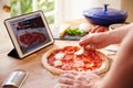 Person Following Pizza Recipe Using App On Digital Tablet Royalty Free Stock Photo