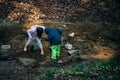 Person in the forest. Asian children fishing with a net to discover nature. Asian Boy and girl playing at a stream Royalty Free Stock Photo
