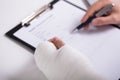 Person With Fractured Hand Filling Health Insurance Form Royalty Free Stock Photo