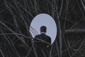 Person in front of mirror that reflect his back, dark concept