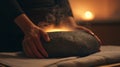 A person gently massaging their abdomen with a heated sauna stone the warmth and pressure promoting healthy flow and