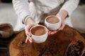 Person giving ceremonial cacao in cup. chocolate drink top view Royalty Free Stock Photo