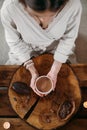 Person giving ceremonial cacao in cup. chocolate drink top view Royalty Free Stock Photo