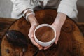 Person giving ceremonial cacao in cup. chocolate drink top view Royalty Free Stock Photo