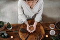 Person giving ceremonial cacao in cup. chocolate drink top view Royalty Free Stock Photo