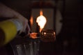 Person glass blowing in the workshop