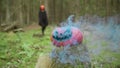 Person goes in mask and coak in the forest on the halloween with smoky pumpkin