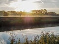 Person going for a run along the river Dijle in Muizen during sunrise