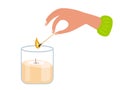 Person going to light candle in glass jar. Human hand holding match stick burning with fire flame with candle. Wooden Royalty Free Stock Photo