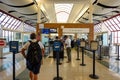 Person going through TSA Precheck line and regular line through airport security