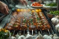 Person grilling meat skewers on grill for Sate Kambing or Suya dish Royalty Free Stock Photo
