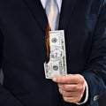 Person, hand and burn money notes as entrepreneur for wealth, rich and corruption of economy. American dollar, paper or Royalty Free Stock Photo