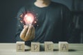 person hand holding power lightbulb and the wooden block has the word idea, inspiration, creativity and imagination concept, Royalty Free Stock Photo