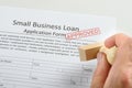 Person hand holding rubber stamp over loan application Royalty Free Stock Photo