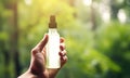 Person hand holding white bottle with mock up with antiallergic nasal spray