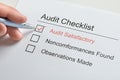 Person hand making tick in audit checklist