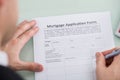 Person Hand Over Mortgage Application Form Royalty Free Stock Photo