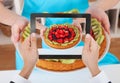 Person hand photographing fruit tart