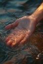 person hand splashing water drops at lake or river, human palm splash aqua