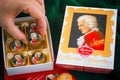 Person hand taking Mozart candy from candy box