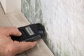 Person Hand Testing The Moldy Wall