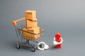 A person is handcuffed to a bunch of boxes a on a supermarket cart. The concept of dependence on shopping and buying new things.