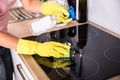 Person Hands Cleaning Induction Stove In Kitchen Royalty Free Stock Photo