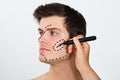 Person Hands Drawing Correction Lines On Male Face