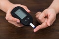 Person Hands Holding Glucometer