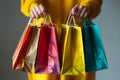 Female hands holding and showing colorful shopping bags Royalty Free Stock Photo