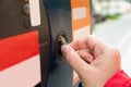 Person Hands Inserting Coin Into Parking Meter