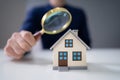 Person Hands With Magnifying Glass And Model House Royalty Free Stock Photo