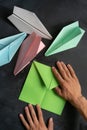 person hands making a origami color paper planes