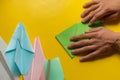 person hands making a origami color paper planes