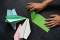 person hands making a origami color paper planes