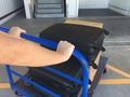 Person hands push trolley luggage